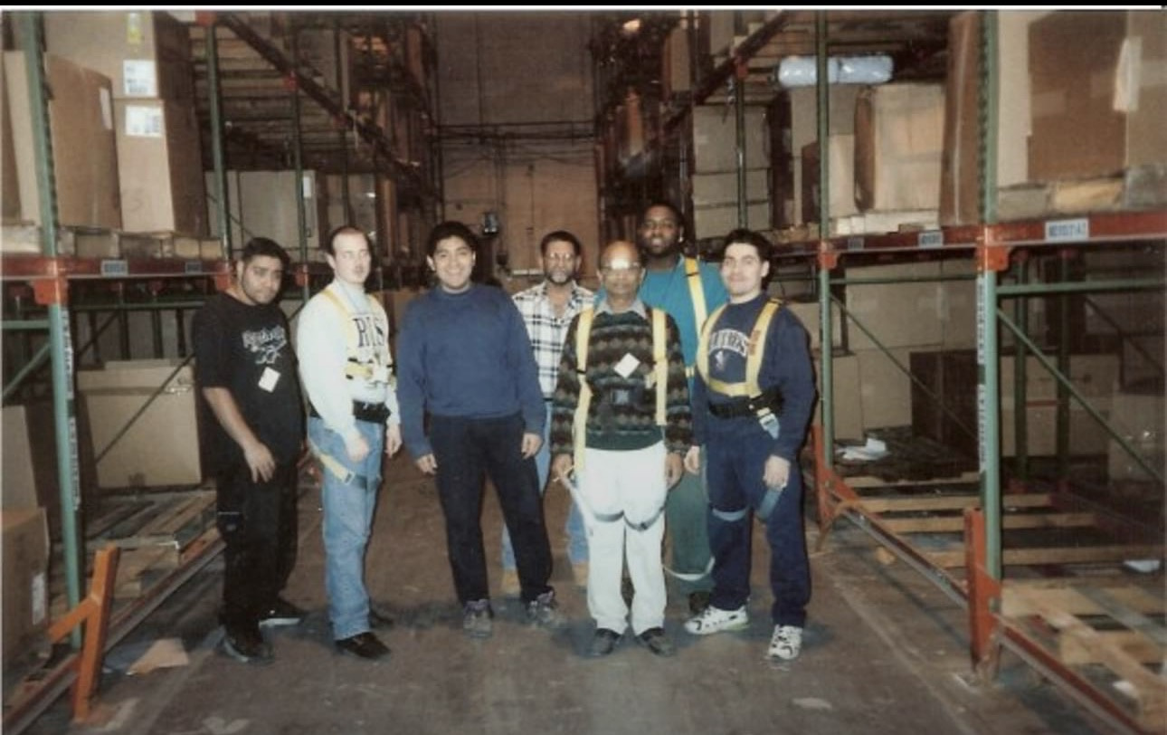 Mathias Bolton with fellow workers at a warehouse in 1995